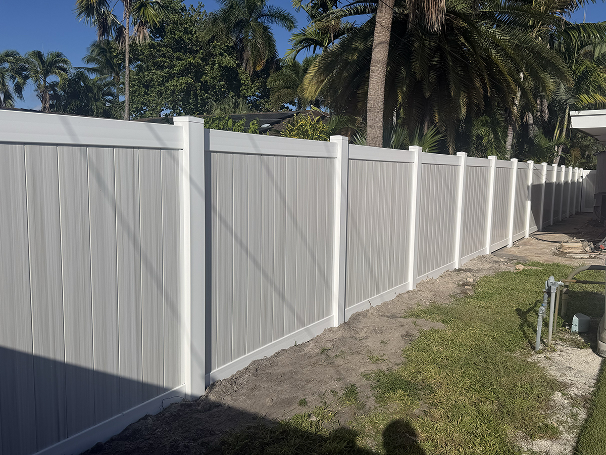 Close perspective of white-framed two-tone Aspen PVC privacy fence panels installed by Atanda Fence in Broward County, FL.